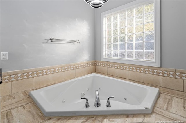 bathroom with tiled tub and a wealth of natural light