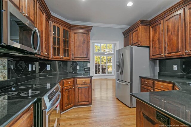363 Kimberwicke Dr, Fayetteville, NC 28311 - kitchen with stainless steel appliances, crown molding, light wood-style floors, glass insert cabinets, and dark stone countertops