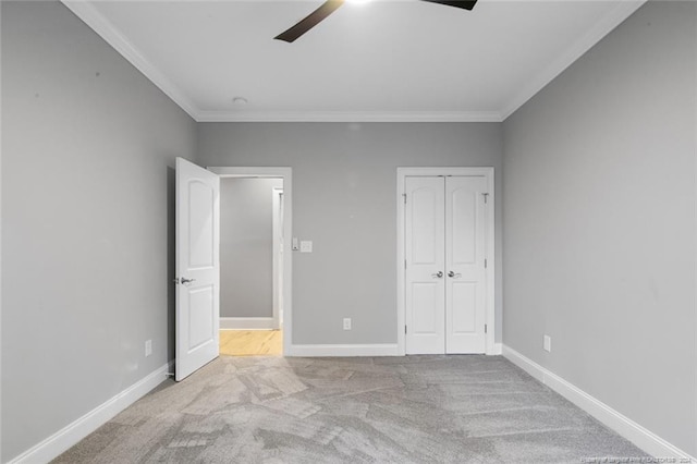 unfurnished bedroom with light carpet, ceiling fan, and crown molding