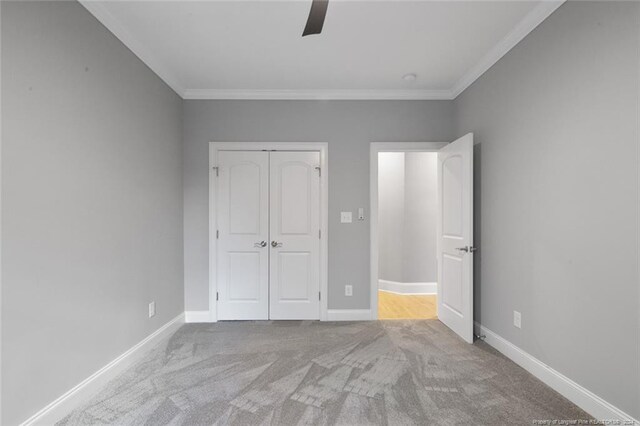 363 Kimberwicke Dr, Fayetteville, NC 28311 - unfurnished bedroom featuring crown molding, carpet floors, a closet, baseboards, and a ceiling fan