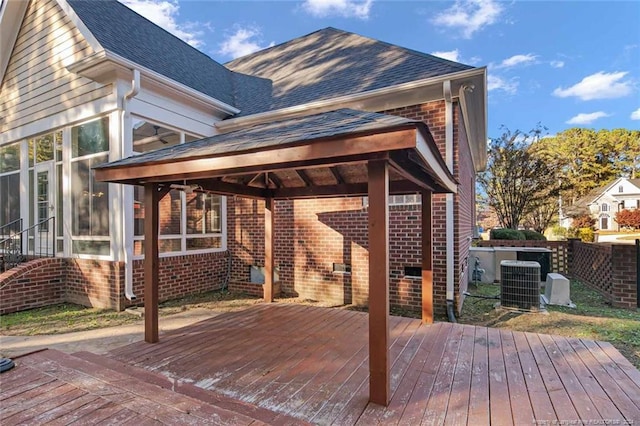 wooden deck with central AC and a sunroom