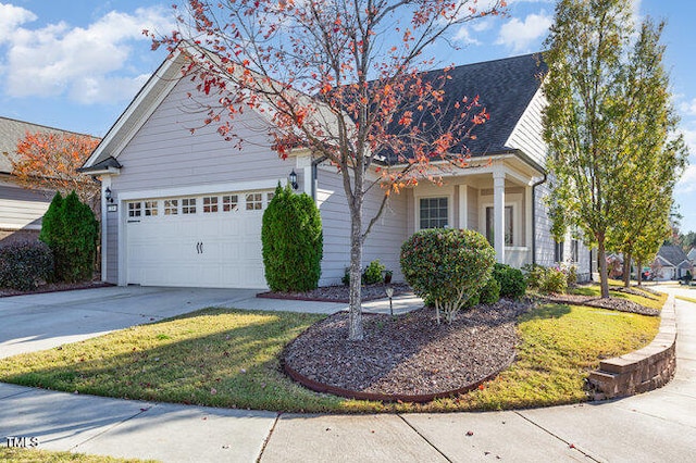 view of front of property with a garage, a front yard, and concrete driveway