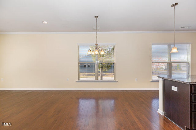 unfurnished dining area with ornamental molding, dark wood-type flooring, plenty of natural light, and baseboards