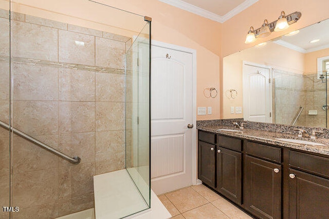 full bathroom featuring tile patterned flooring, a sink, ornamental molding, tiled shower, and double vanity