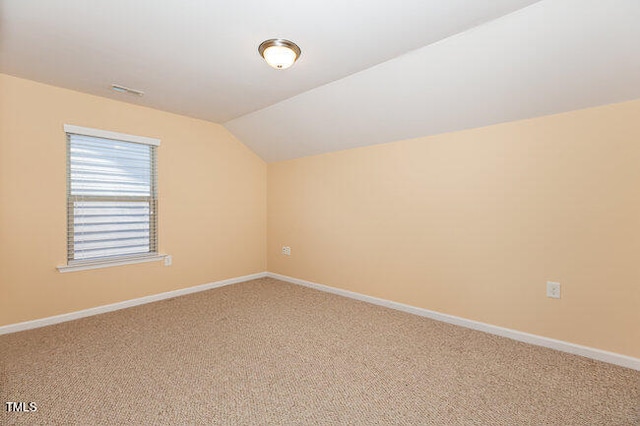 bonus room featuring carpet, vaulted ceiling, and baseboards