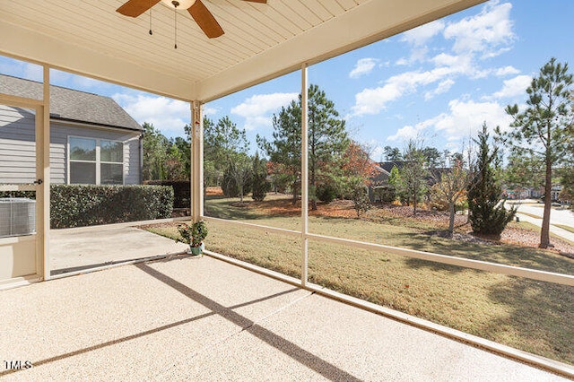 unfurnished sunroom featuring ceiling fan