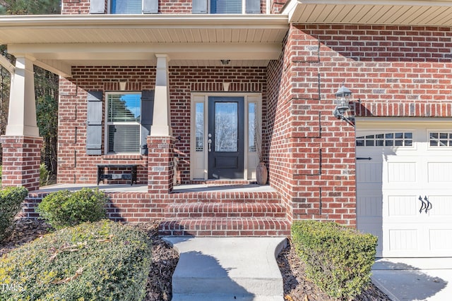 doorway to property with a porch and a garage