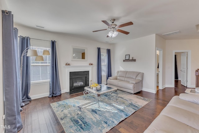 living room featuring dark hardwood / wood-style flooring and ceiling fan