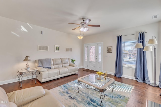 living room with ceiling fan and dark hardwood / wood-style flooring