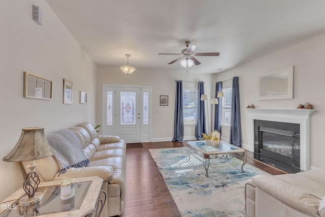 living room with dark hardwood / wood-style floors, ceiling fan, and a wealth of natural light