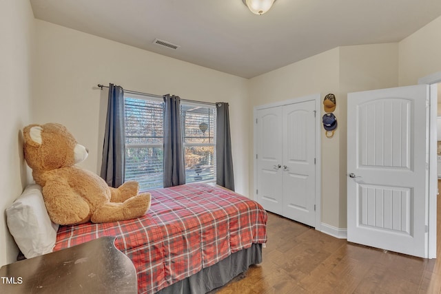 bedroom featuring hardwood / wood-style floors and a closet