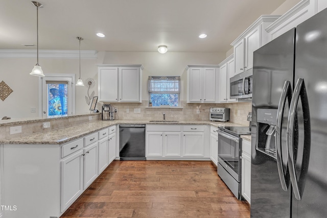 kitchen featuring black appliances, white cabinets, kitchen peninsula, and hanging light fixtures