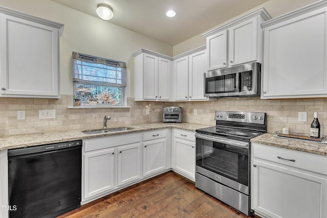 kitchen with dark wood-type flooring, white cabinetry, sink, and stainless steel appliances