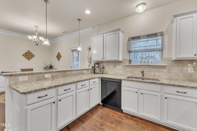 kitchen with sink, black dishwasher, kitchen peninsula, decorative light fixtures, and hardwood / wood-style flooring