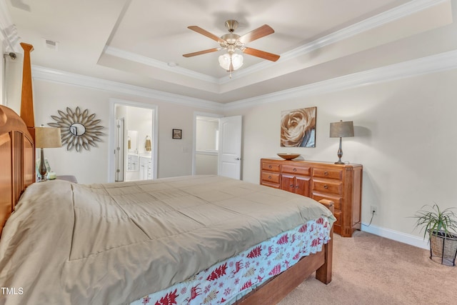 bedroom with light carpet, ornamental molding, a raised ceiling, ceiling fan, and connected bathroom