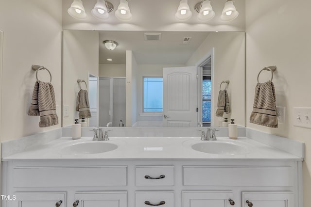 bathroom featuring vanity and a shower with door