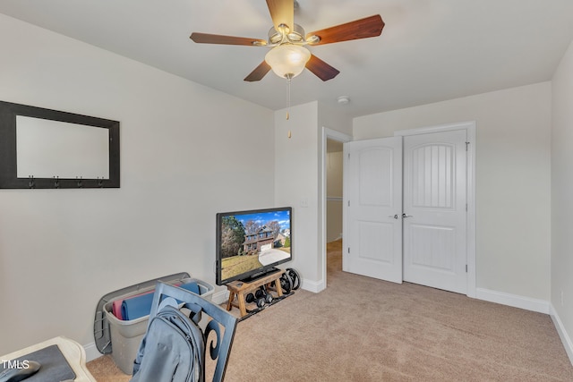 playroom featuring light carpet and ceiling fan