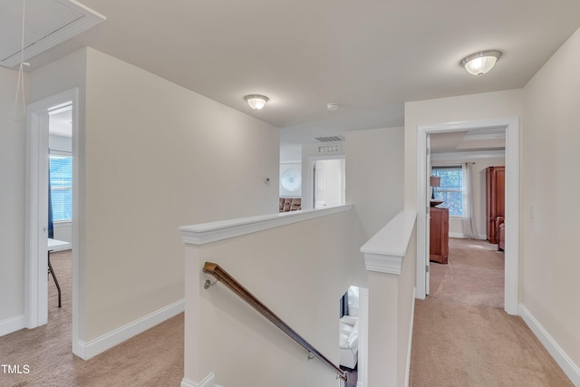 hall featuring light colored carpet