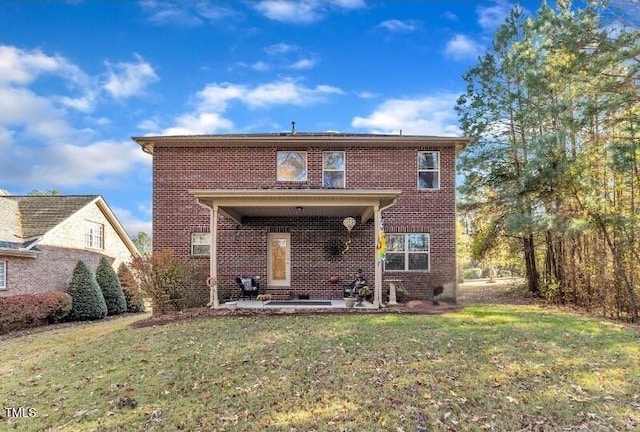 view of front of house with a patio area and a front lawn