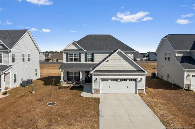 view of front of property featuring central AC unit, a garage, and a front yard