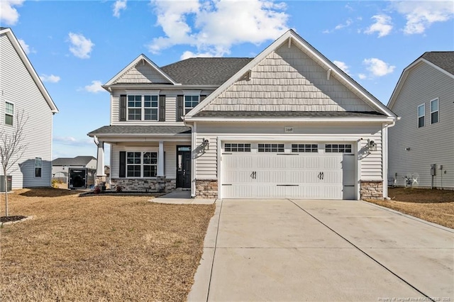 craftsman house featuring a garage, a front yard, and a porch