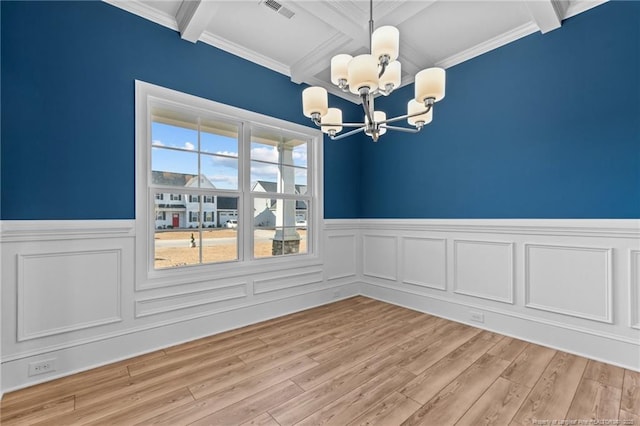 unfurnished dining area featuring coffered ceiling, beamed ceiling, light hardwood / wood-style flooring, and an inviting chandelier