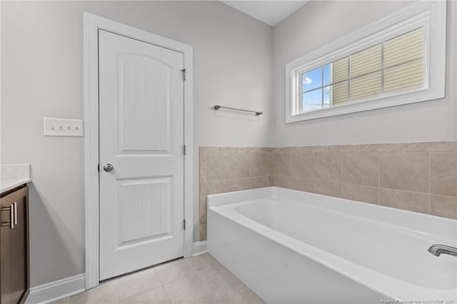 bathroom featuring vanity, a tub, and tile patterned flooring