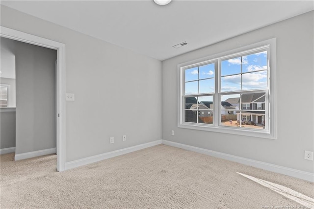 spare room with light colored carpet