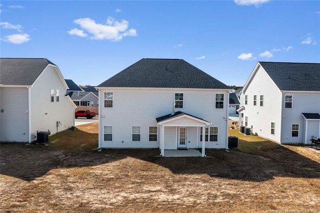 rear view of house with a patio area and central AC