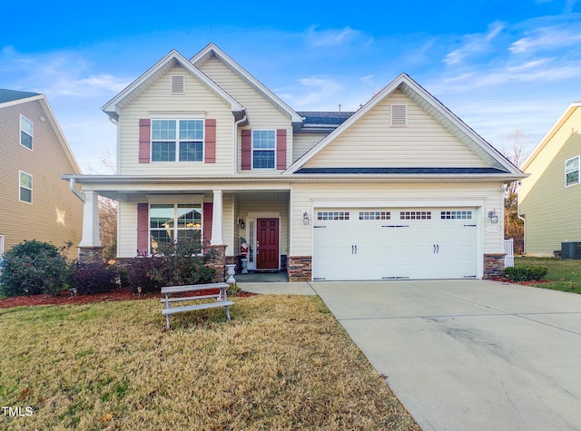 craftsman-style home with cooling unit, a front lawn, covered porch, and a garage