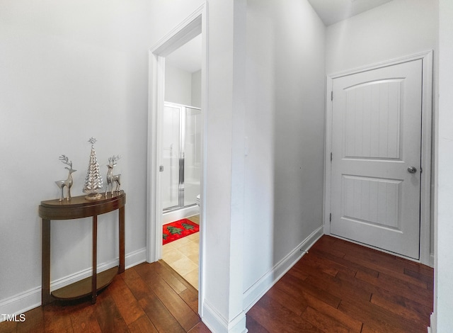 corridor with dark hardwood / wood-style flooring