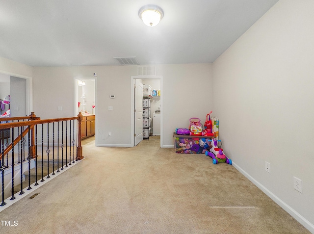 rec room with light colored carpet