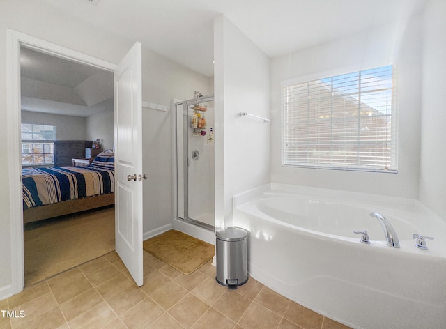 bathroom with shower with separate bathtub, tile patterned floors, and a wealth of natural light