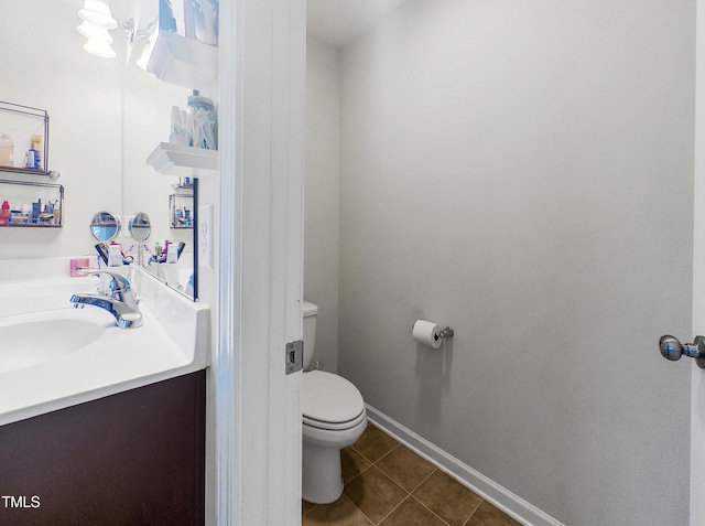 bathroom with tile patterned flooring, vanity, and toilet