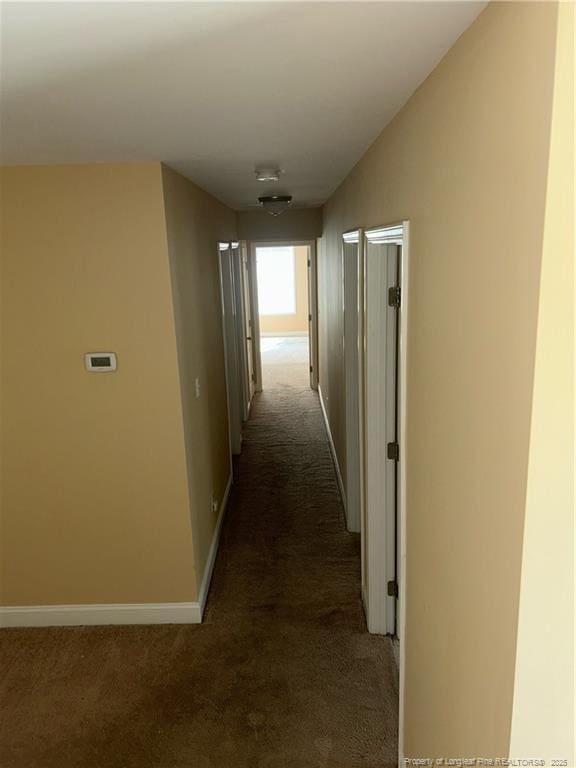6605 Stillwood Dr, Hope Mills, NC 28348 - hallway with baseboards, vaulted ceiling, and carpet flooring