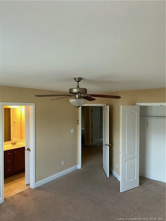 6605 Stillwood Dr, Hope Mills, NC 28348 - unfurnished bedroom featuring light carpet, baseboards, a closet, and connected bathroom