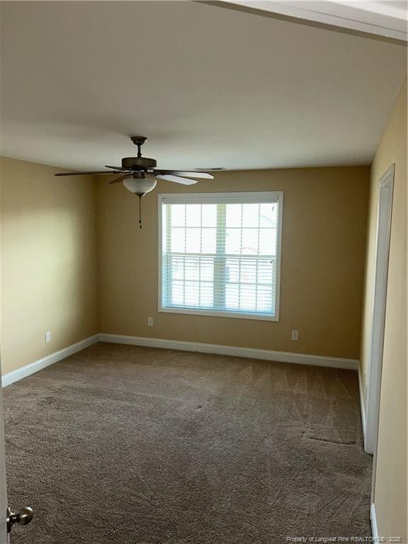 6605 Stillwood Dr, Hope Mills, NC 28348 - carpeted spare room with baseboards and ceiling fan