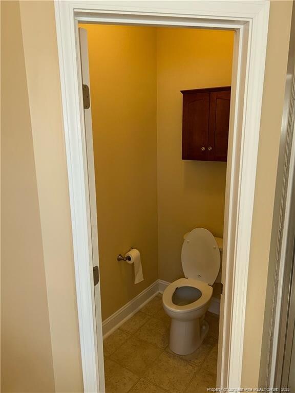6605 Stillwood Dr, Hope Mills, NC 28348 - bathroom featuring baseboards and toilet