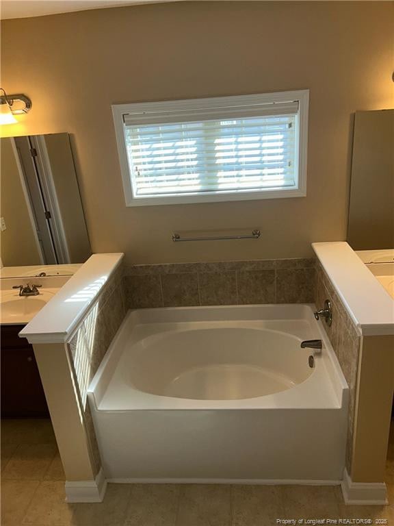 6605 Stillwood Dr, Hope Mills, NC 28348 - bathroom featuring a bath, tile patterned flooring, vanity, and plenty of natural light
