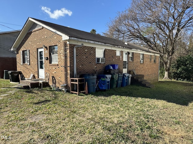 back of property with cooling unit and a lawn