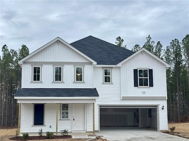 modern farmhouse with a porch, concrete driveway, and an attached garage