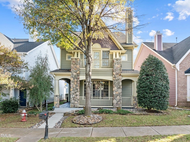 view of front of house with a balcony and covered porch