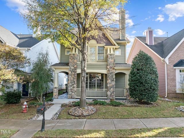 view of front of property with a balcony and a porch