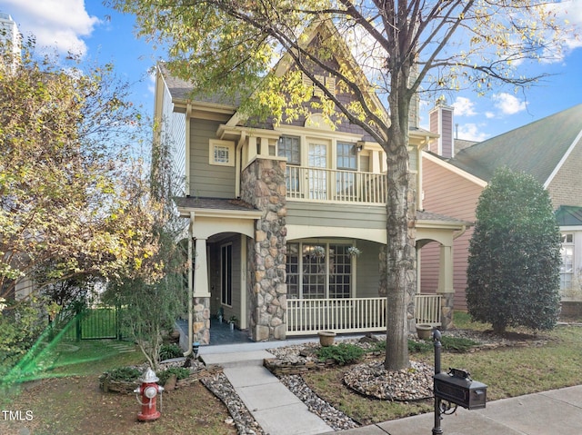 view of front of property with a porch and a balcony