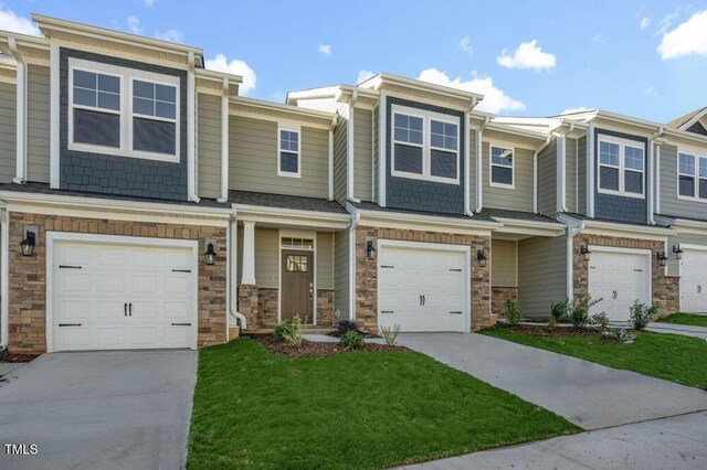 multi unit property featuring a front lawn and a garage