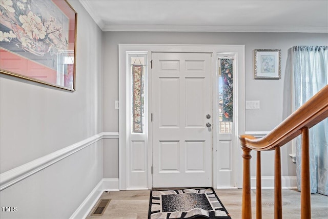 entrance foyer featuring light hardwood / wood-style flooring and crown molding