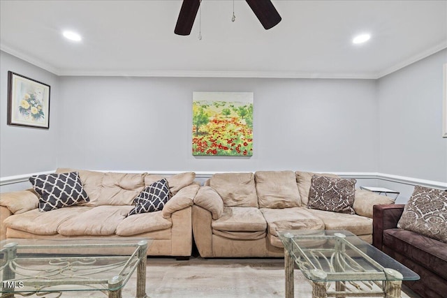 living room with crown molding, light hardwood / wood-style flooring, and ceiling fan