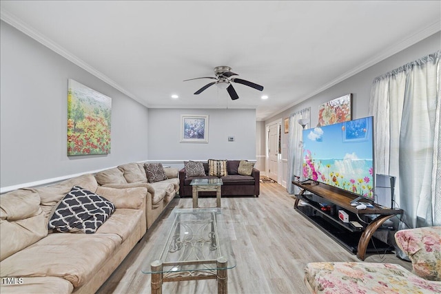 living room with crown molding, ceiling fan, and light hardwood / wood-style floors