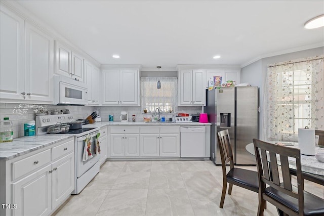 kitchen featuring decorative backsplash, white appliances, sink, pendant lighting, and white cabinetry