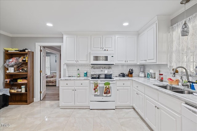 kitchen with white appliances, sink, ornamental molding, tasteful backsplash, and white cabinetry